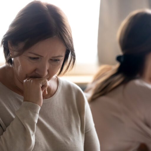 Sad senior mother involved in family quarrel with adult daughter who is caring for aging parents
