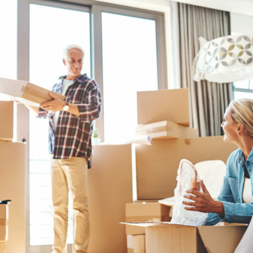 investment and retirement with old people unpacking in the living room of their new apartment