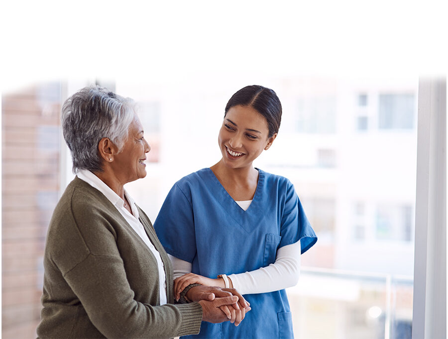 Young female nurse comforts senior woman with a hand on her arm