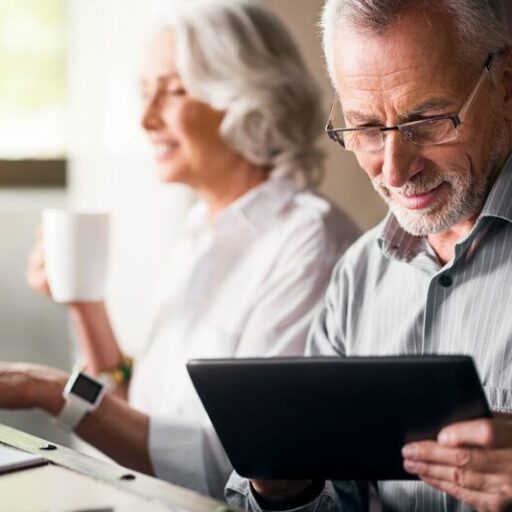 An older couple uses their devices. This technology helps seniors age in place.