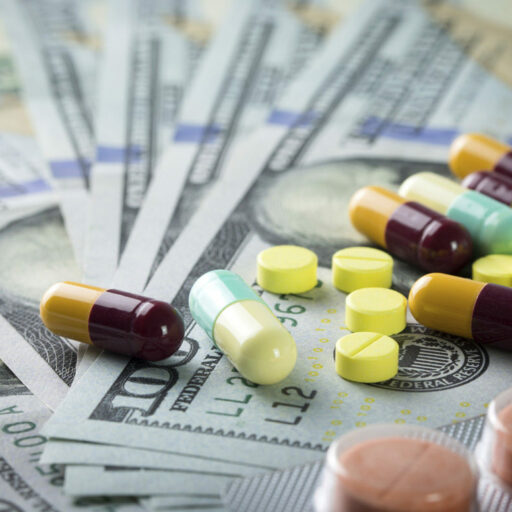 Pills and dollar bills laid out to represent health care cost