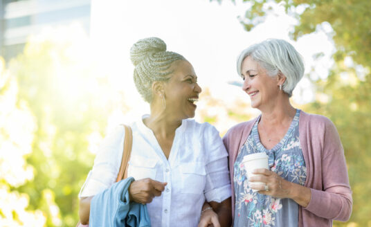Two women walking in park | Honor caregivers in your life