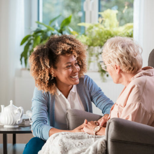 A senior woman chats with her nurse in her apartment at the skilled nursing home.