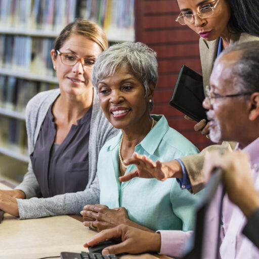 A group of adults and seniors taking part in library programs