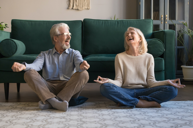 A senior man and a senior woman doing yoga and other methods of how to live longer