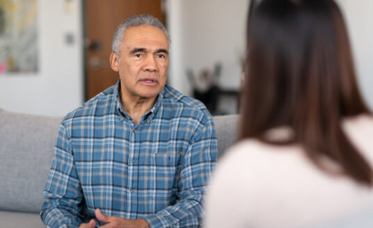Lady talking to elderly man about sensitive topics