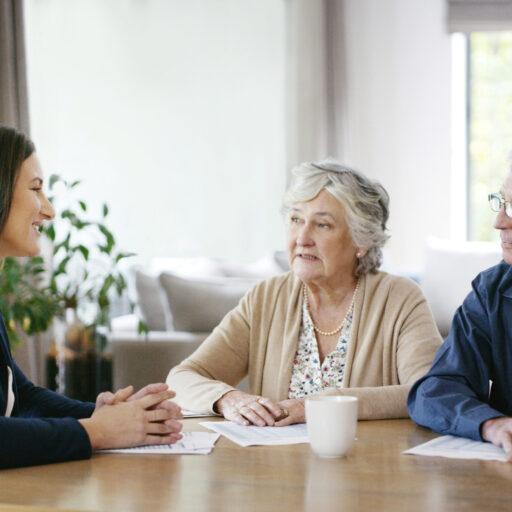 Advisor explaining health care documents to senior couple