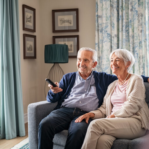 Senior couple watching tv shows and movies on streaming services for seniors