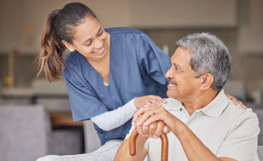 Senior care worker providing senior home care solutions to elderly man