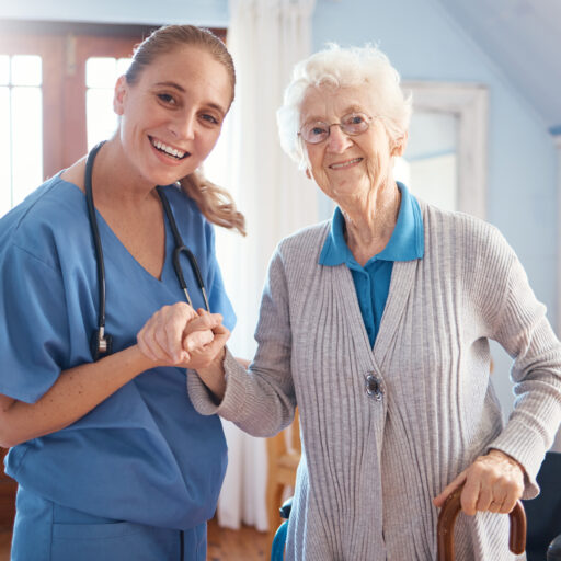 Senior care nurse helping elderly woman