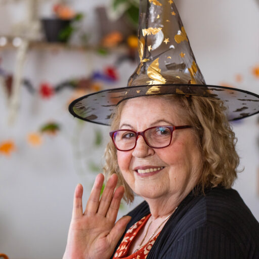 Senior woman dressed as witch, showcasing easy Halloween costumes for seniors