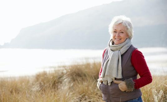 A senior woman focuses on winter health by getting outside on a nice winter day.