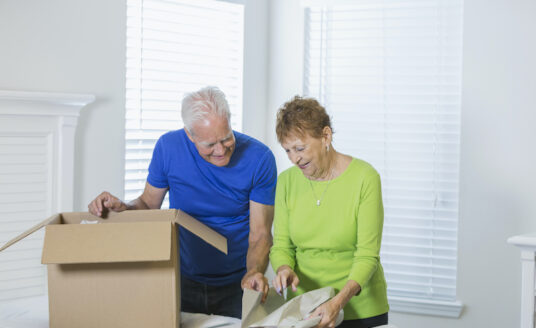 A senior couple packs up their home as they prepare for moving to an Independent Living Community.