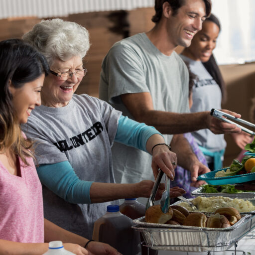 A group of volunteers, young and old. Volunteer at a senior living community to benefit both the residents and the individual volunteers.