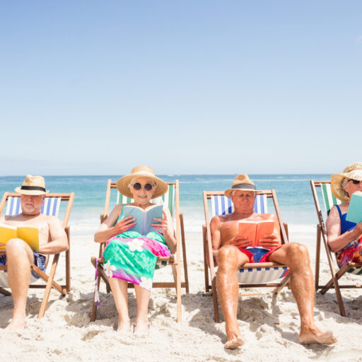 Traveling seniors relaxing at the beach
