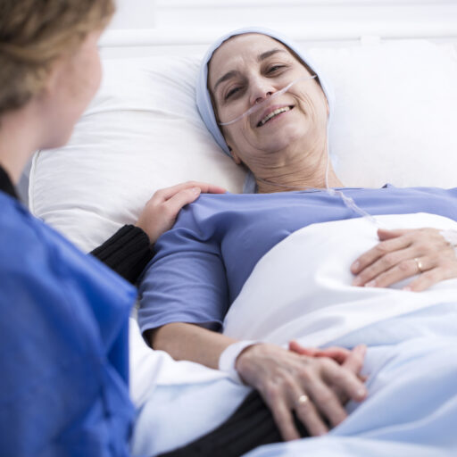 A woman talks to her loved one in hospice care.