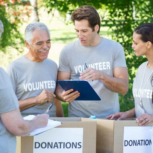 A group of senior and adult volunteers collect donations and experience the benefits of doing community service