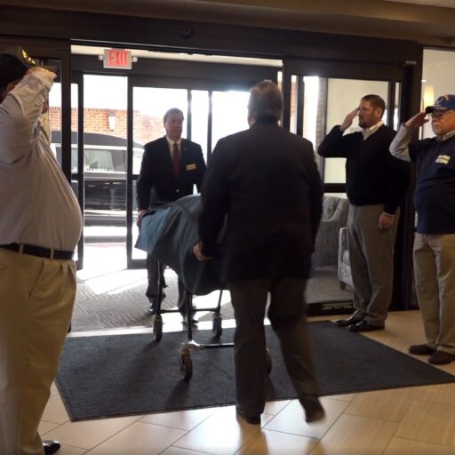 Residents saluting during Veteran Escort Ceremony